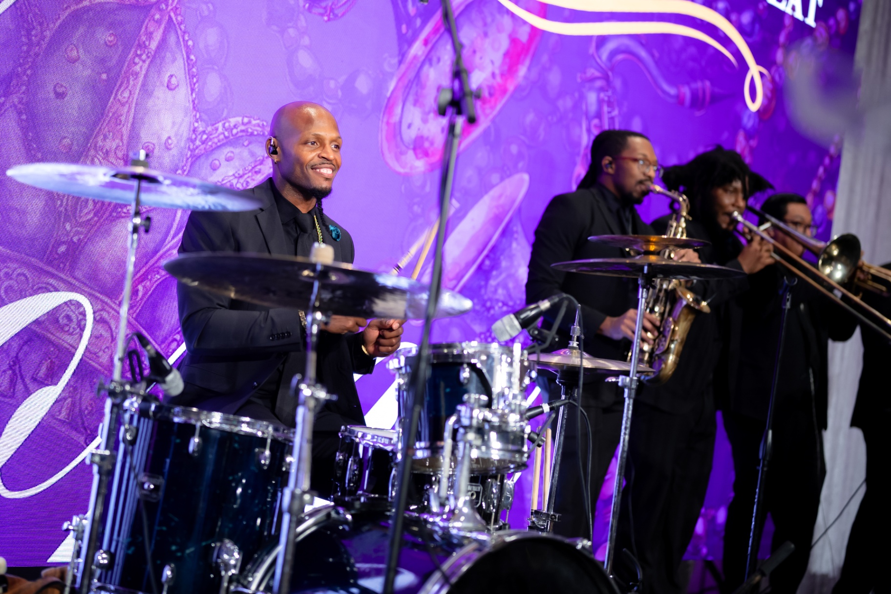 Drummer and horn section performing at the Memory Ball